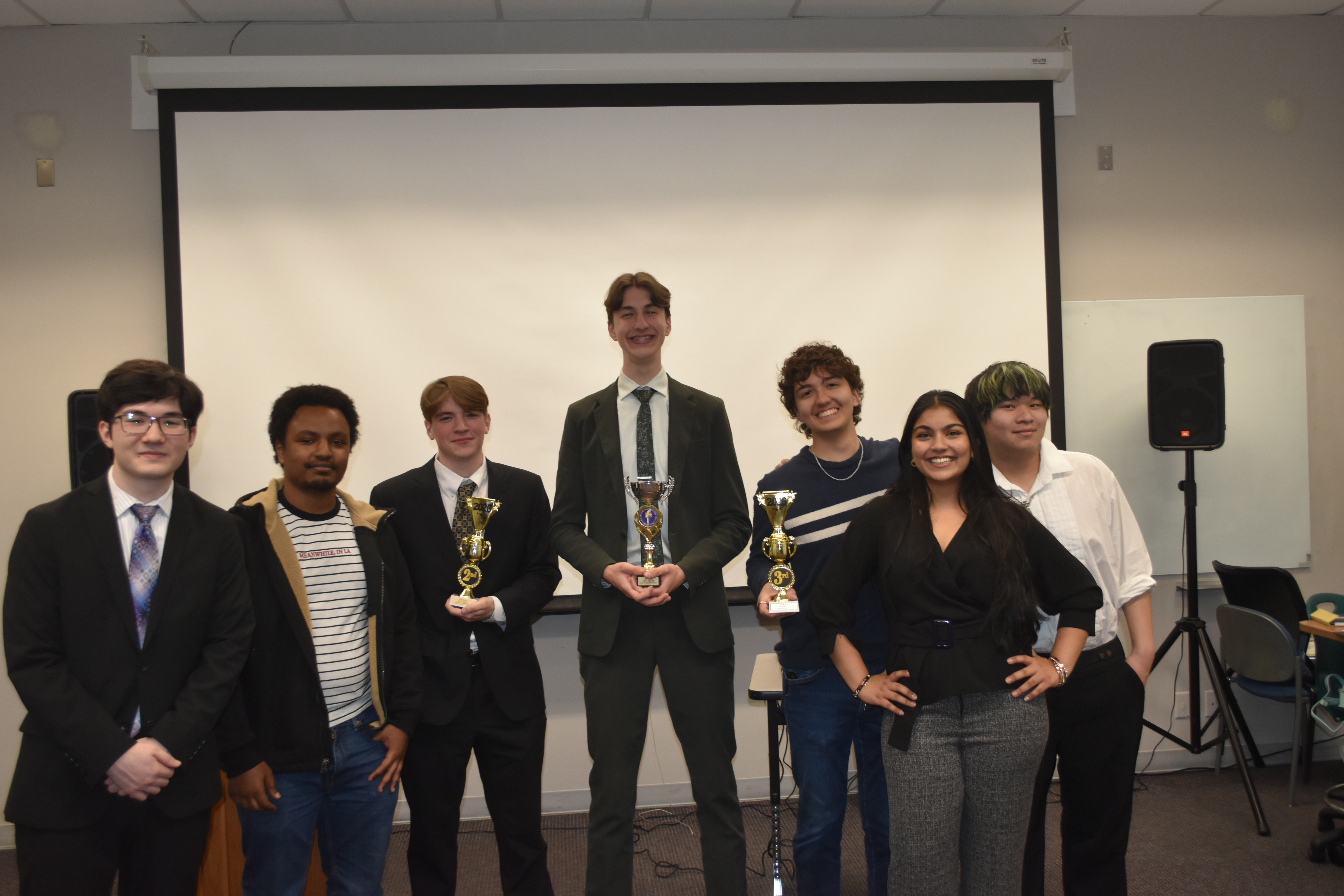 debate night winners with the runner ups and the Debate Club board