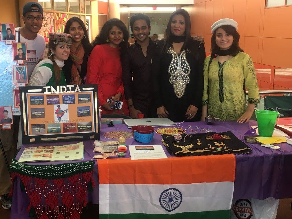 College of DuPage CCI participants showcase international currency, flags, and jewelry at International Education Week.