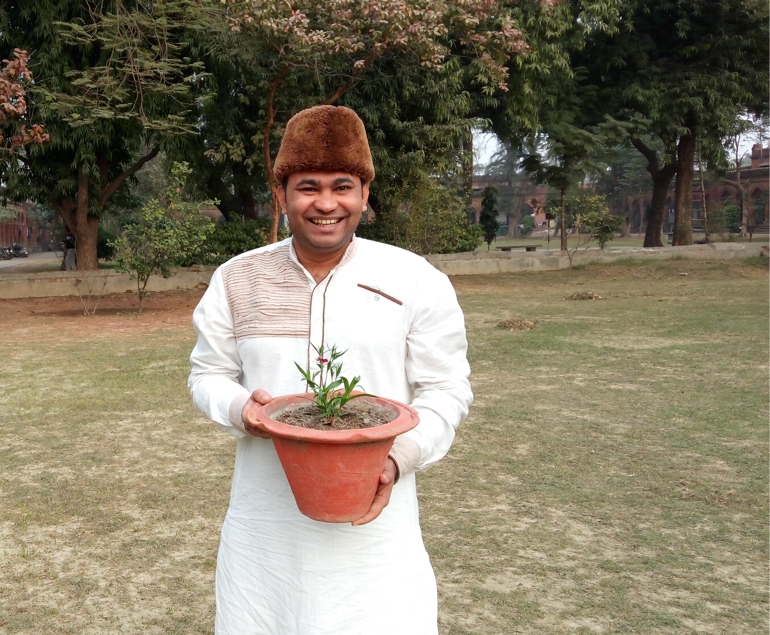 Seth Zulfiqar stands with his CCI seeds plants