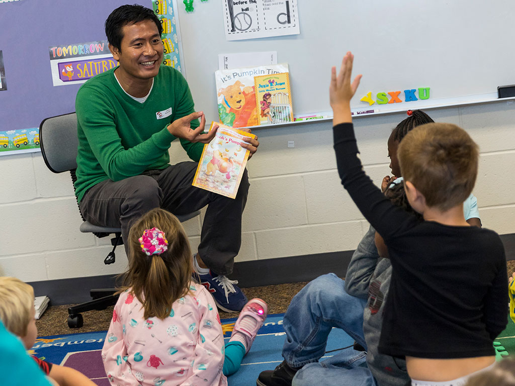 Adi reading to school children at America Reads