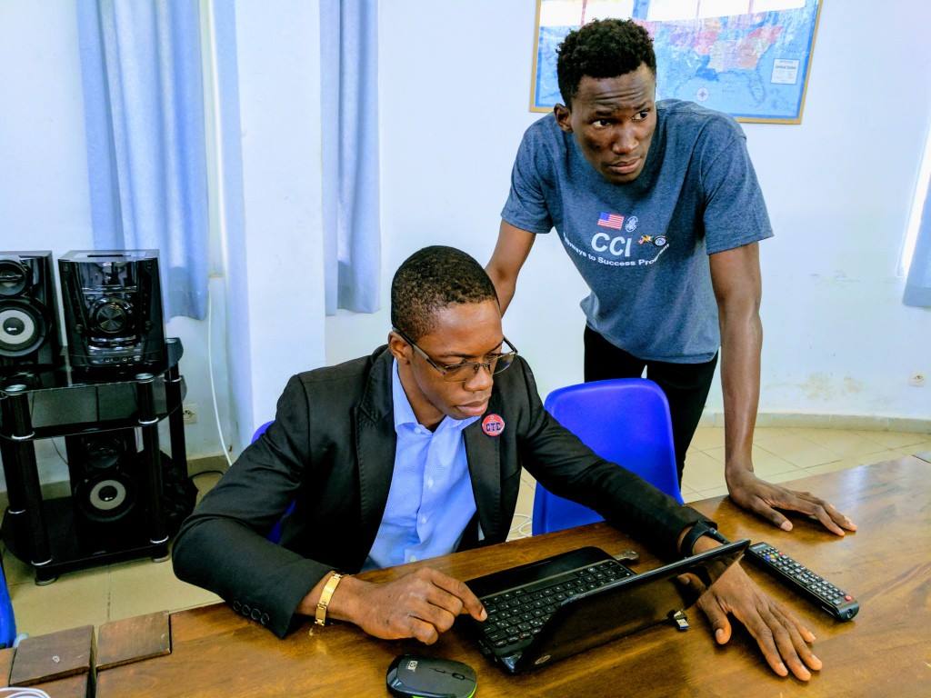 Hermes and Venance prepare to give a presentation.