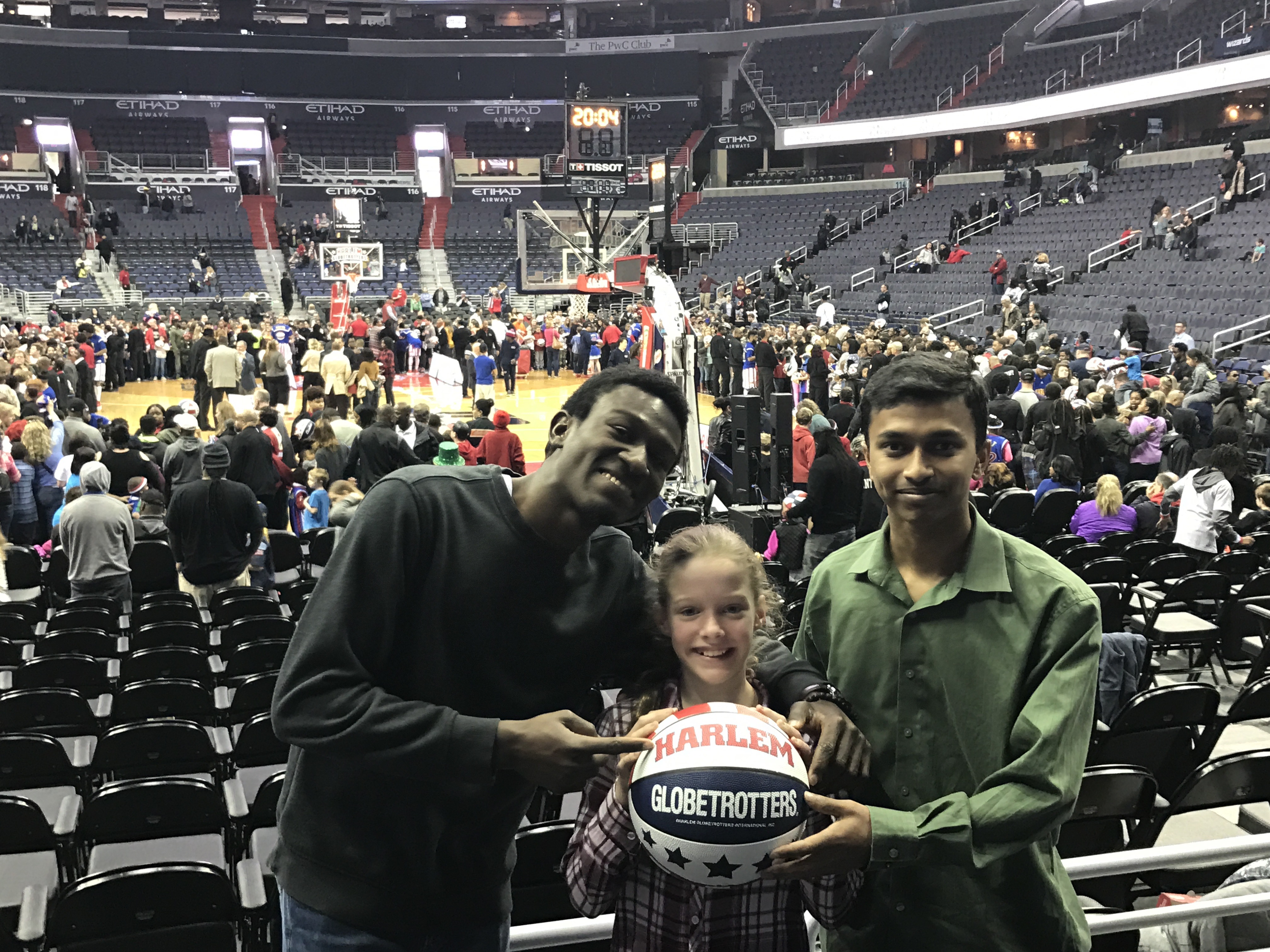 CCI participants Ebenezer and Mehedi at a Harlem Globetrotters game with Doreen’s daughter.