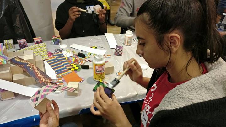 Yasemin Betni, a CCI Bunker Hill Community College student from Turkey, decorates blocks to send to Boston public school children.