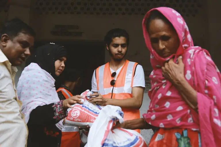 Syed Minhaj Hossain hands out goofs to poeple affected by the floods in Bangladesh
