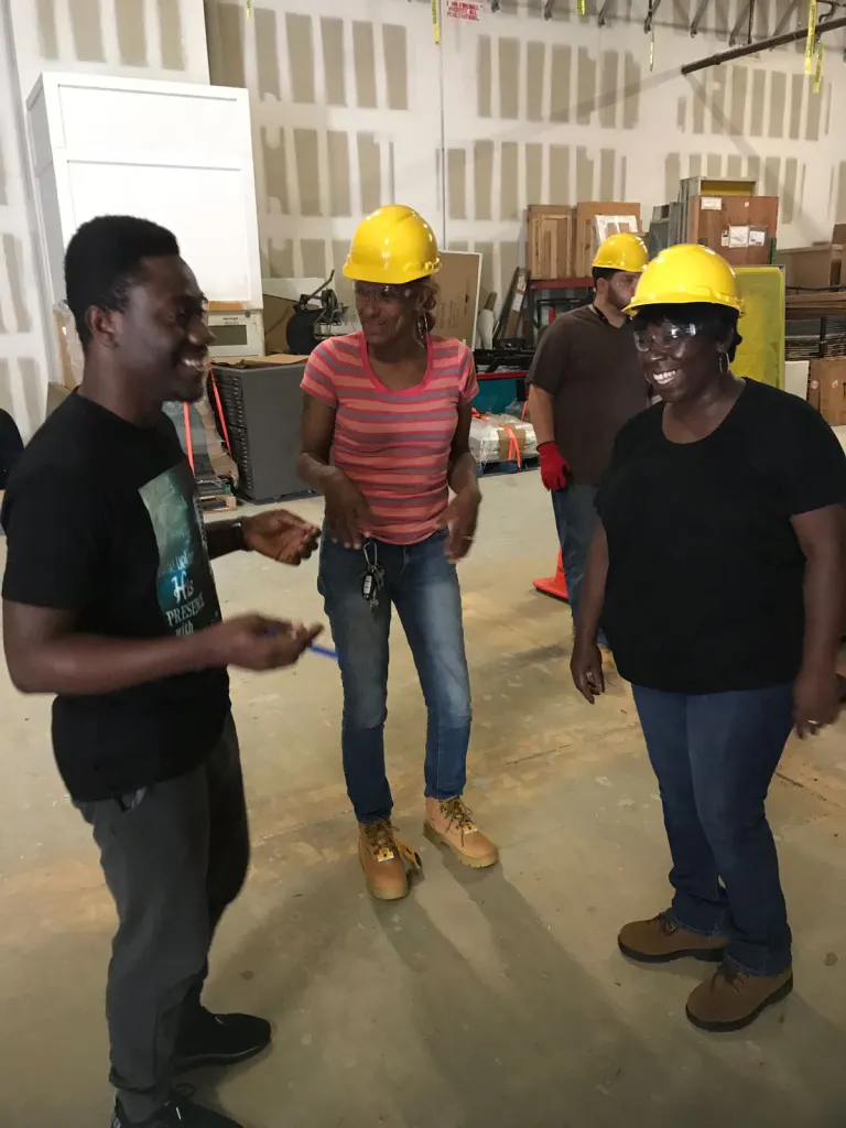 Kwame helps guides students through learning vocational skills in construction