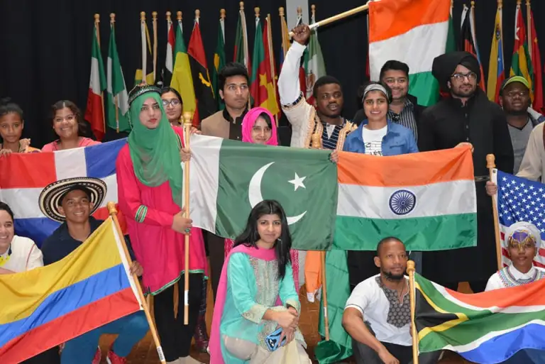 CCI participants and other international exchange students at Northampton Community College pose together with their country flags in celebration of International Education Week 2017.