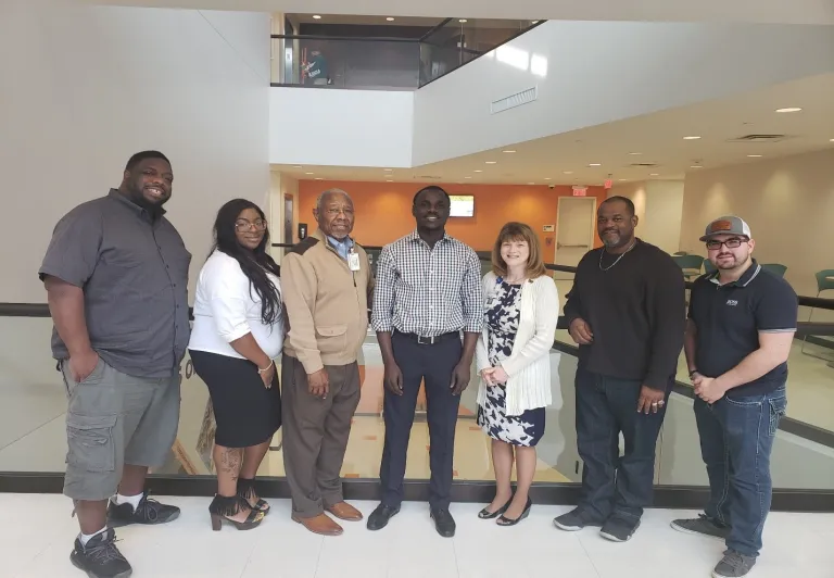 CCI participant Kandiosky N’guessan (center) and the other officers of the HCC Logistics Student Club during a meeting with professor James Battieste (third from left) and the Dean of Logistics Center of Excellence, Dr. Porter (third from right). [Photo courtesy of HCC Logistics Club]