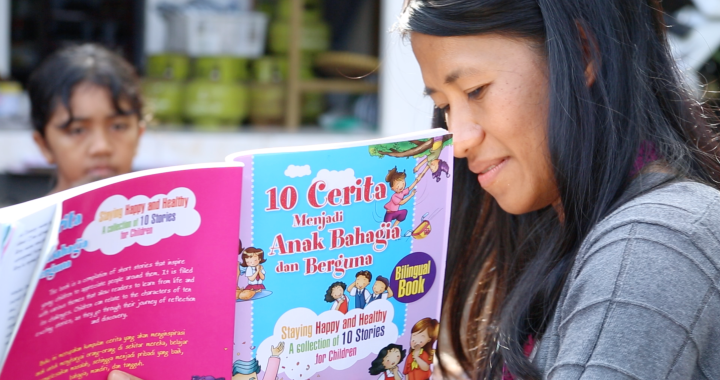 CCI alumna Ziadah reads to children in Lombok, Indonesia.