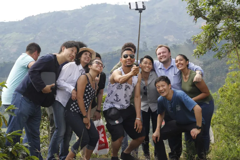 Luisa poses for a selfie with Brazilian and Japanese tourists to Colombia as she serves as a translator.