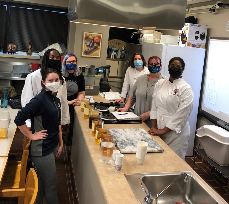 CCI participants in Sinclair Community College’s Culinary Program pose together in their learning kitchen