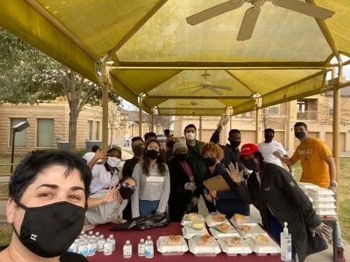 CCI Program Coordinator Odeta Zheku takes a selfie with the Houston Community College cohort while they are distributing food during the Marking Luther King Jr. Day of Service event.