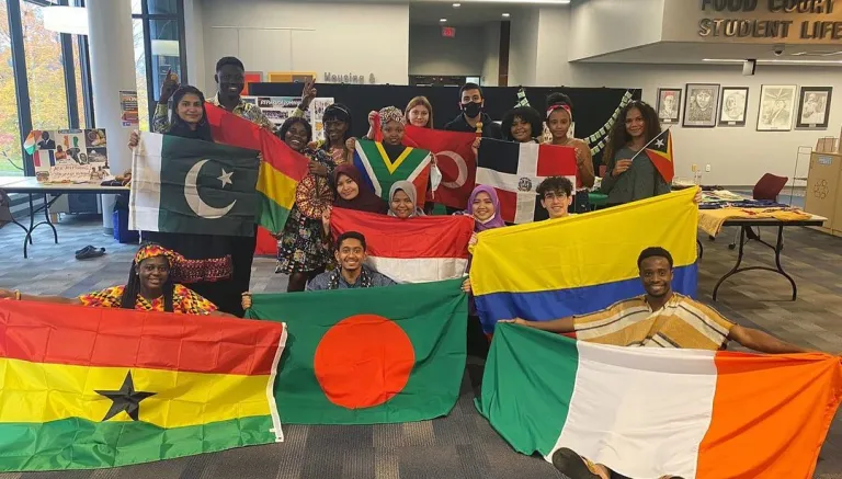 CCI participants at Northampton Community College pose together with their national flags during International Education Week