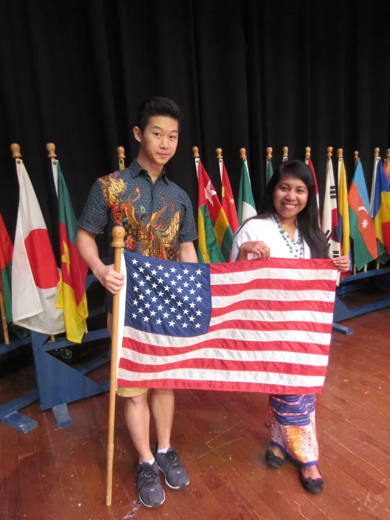 Dince Abanat holding an American flag with a fellow Indonesian student during the International Education Week celebrations at Northampton Community College in 2016.