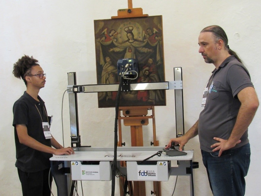 Jonas working on a painting with his research mentor