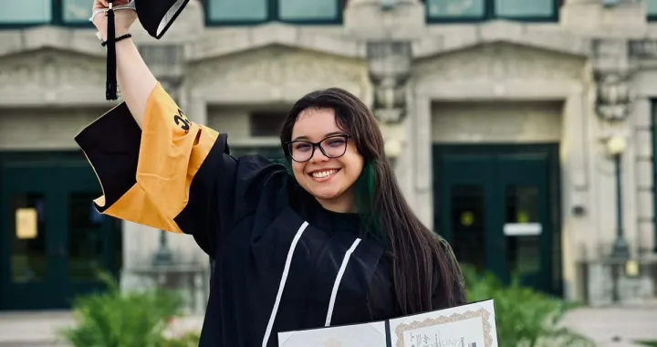 Leticia with cap and gown during graduation