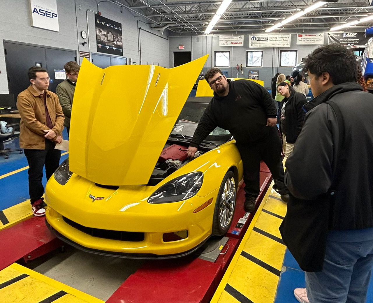 Students with yellow car