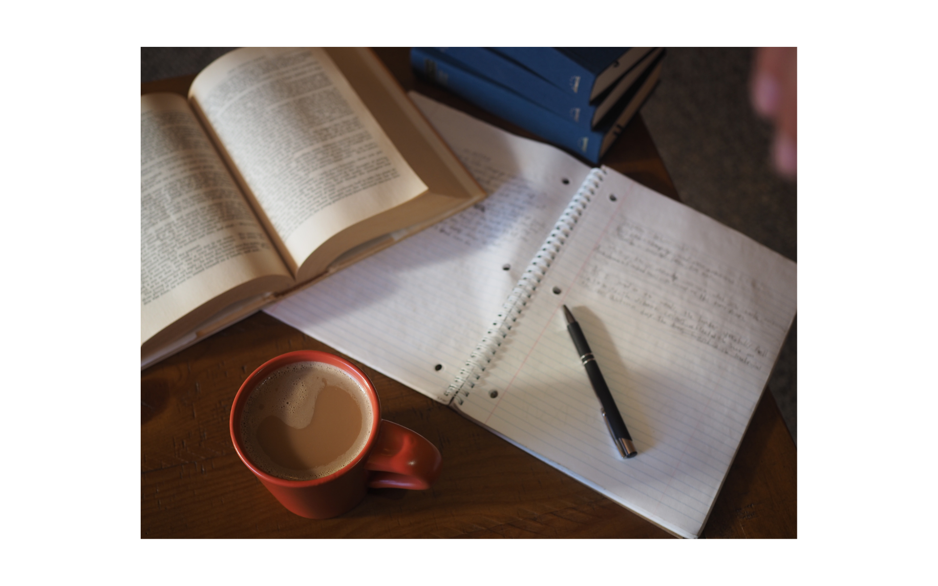 An overhead view of a notebook and book. 
