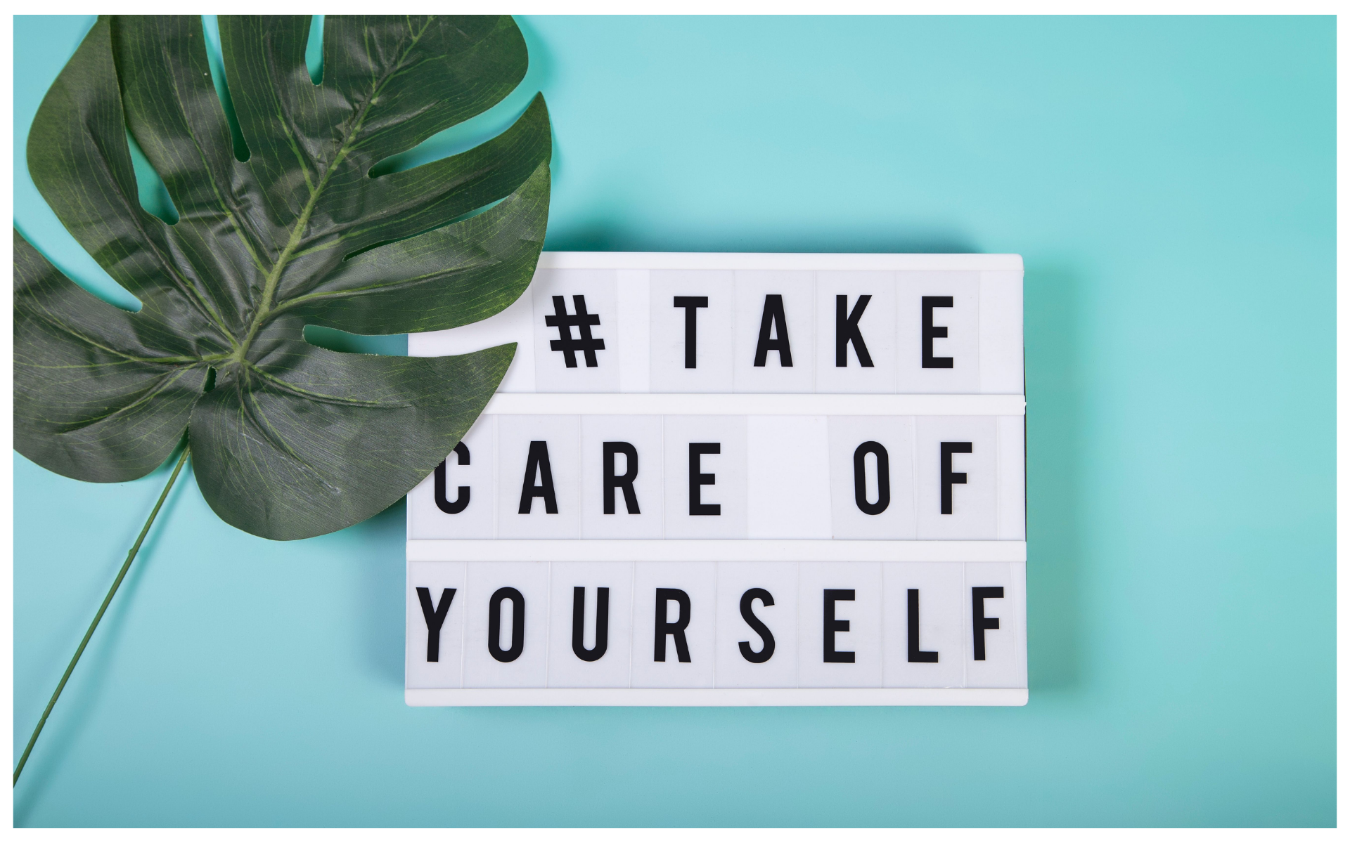 A sign with a palm leaf that says take care of yourself. 