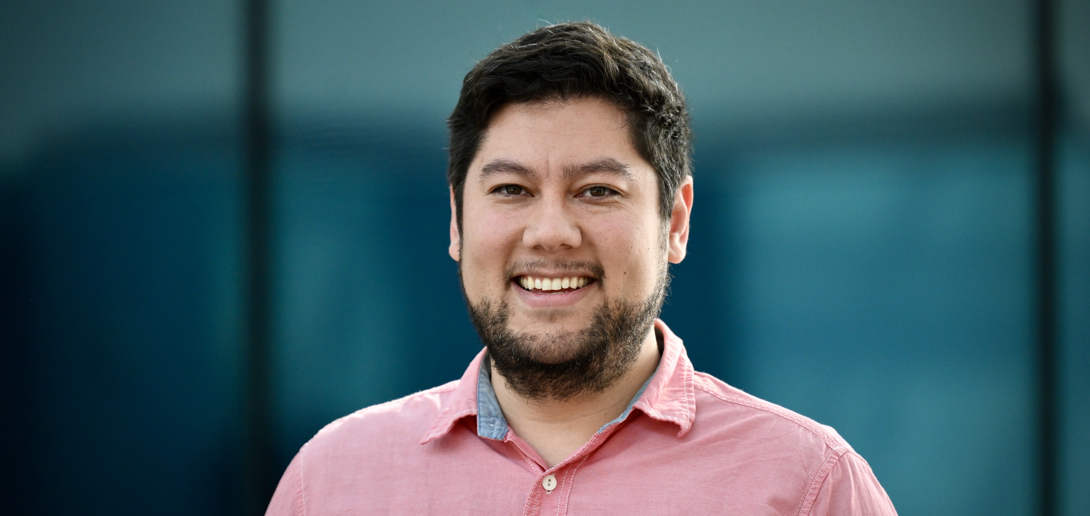 A photo of Kenji Reed smiling at the camera