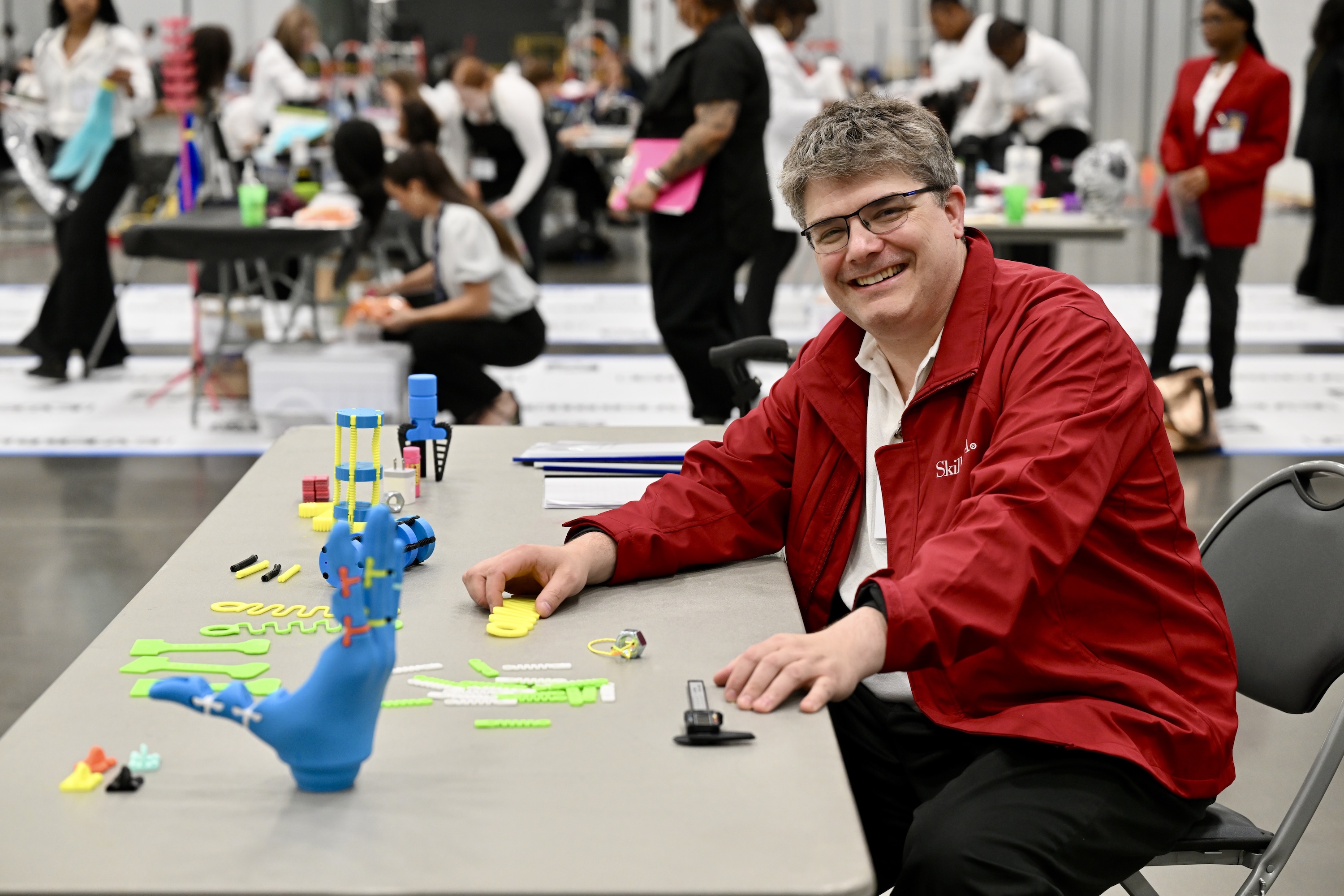 JR at SkillsUSA national competition table with 3D printed items